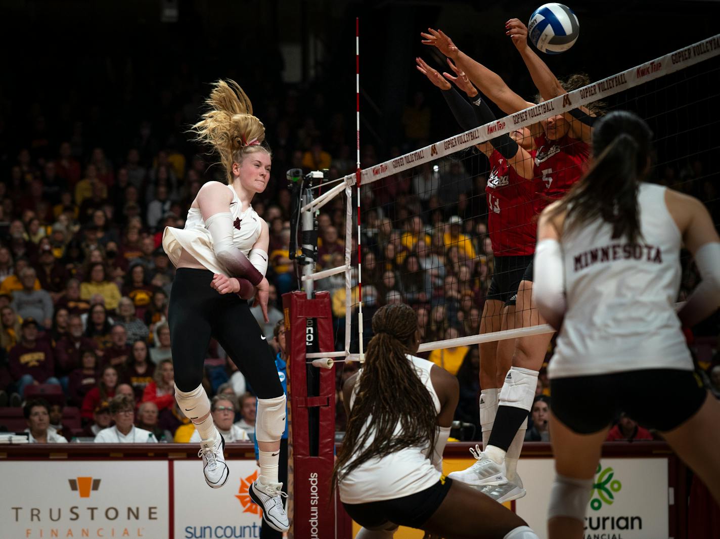 Minnesota outside Mckenna Wucherer (3) spikes the ball against the University of Nebraska blockers at the volleyball game at the Maturi Pavilion in Minneapolis on Saturday, Nov. 25, 2023. ] Angelina Katsanis • angelina.katsanis@startribune.com