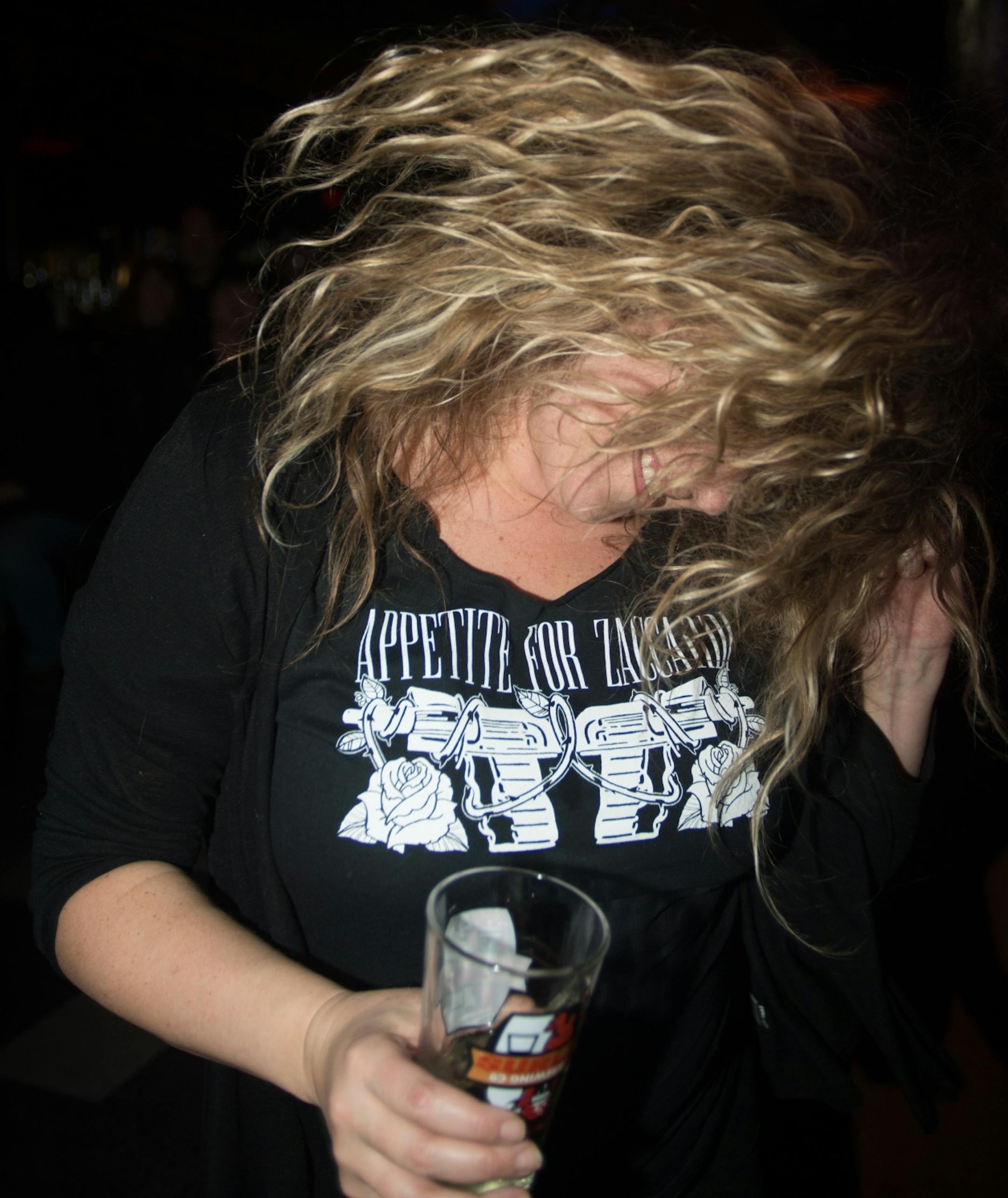 Laura Preston dances to the music played by Appetite for Zaccardi at Turf Club early Saturday morning.