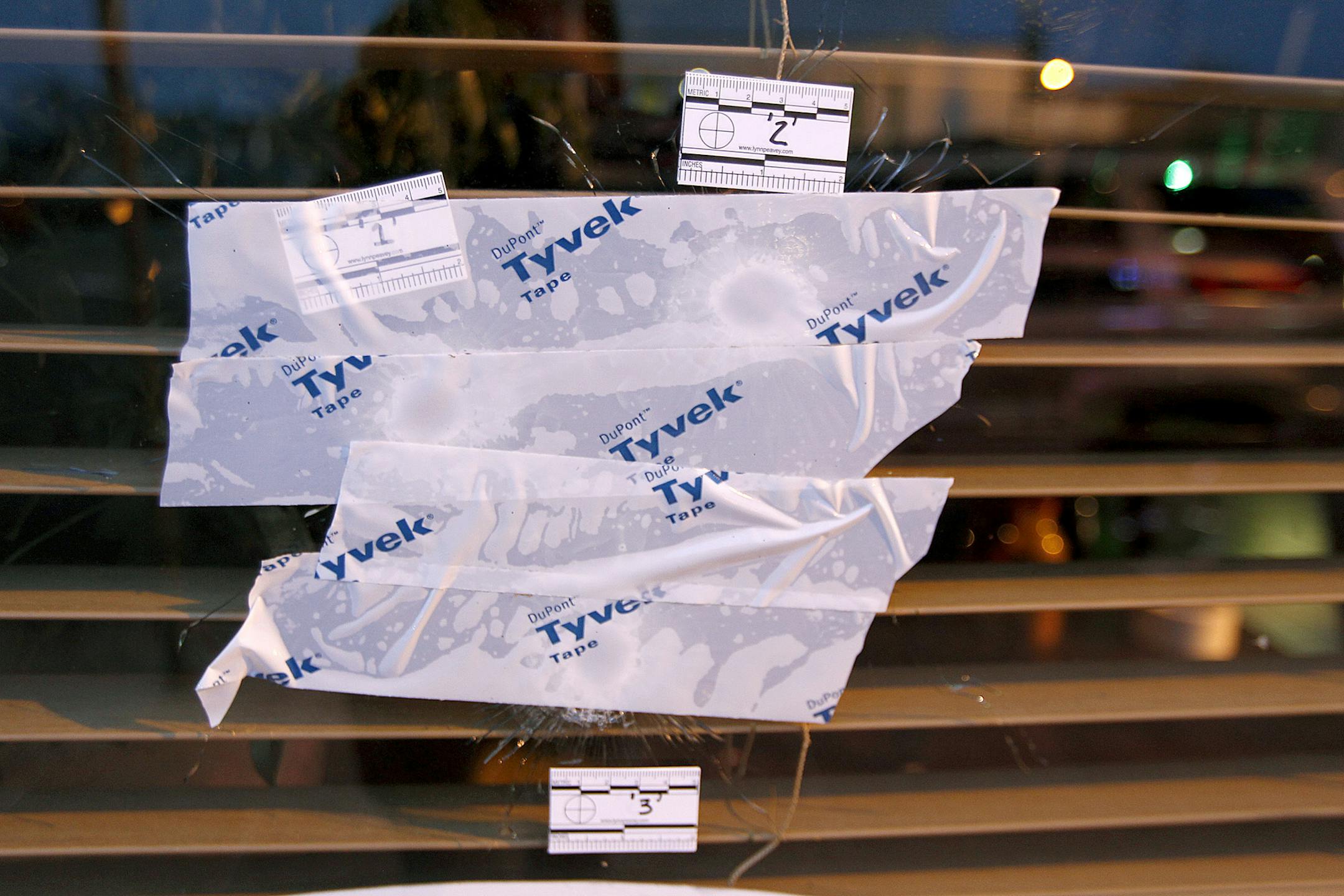 Bullet holes were covered with tape outside La Que Buena Seafood Restaurant where police were called to the restaurant in south Minneapolis around 1:30 a.m., Monday, November 25, 2013.