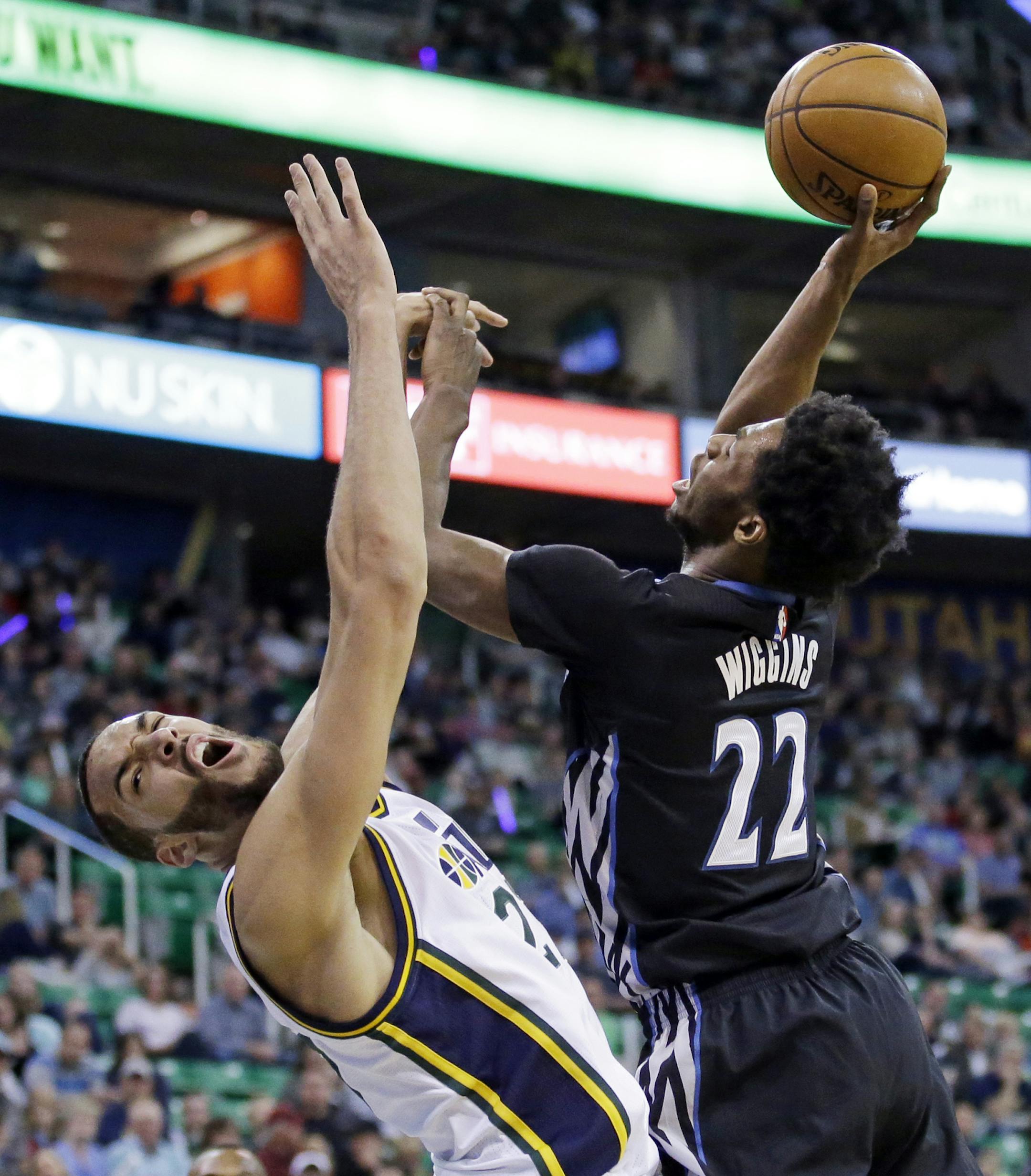 Minnesota Timberwolves guard Andrew Wiggins (22) goes to the basket as Utah Jazz center Rudy Gobert, left, defends during the first quarter of an NBA basketball game Friday, April 1, 2016, in Salt Lake City. (AP Photo/Rick Bowmer)