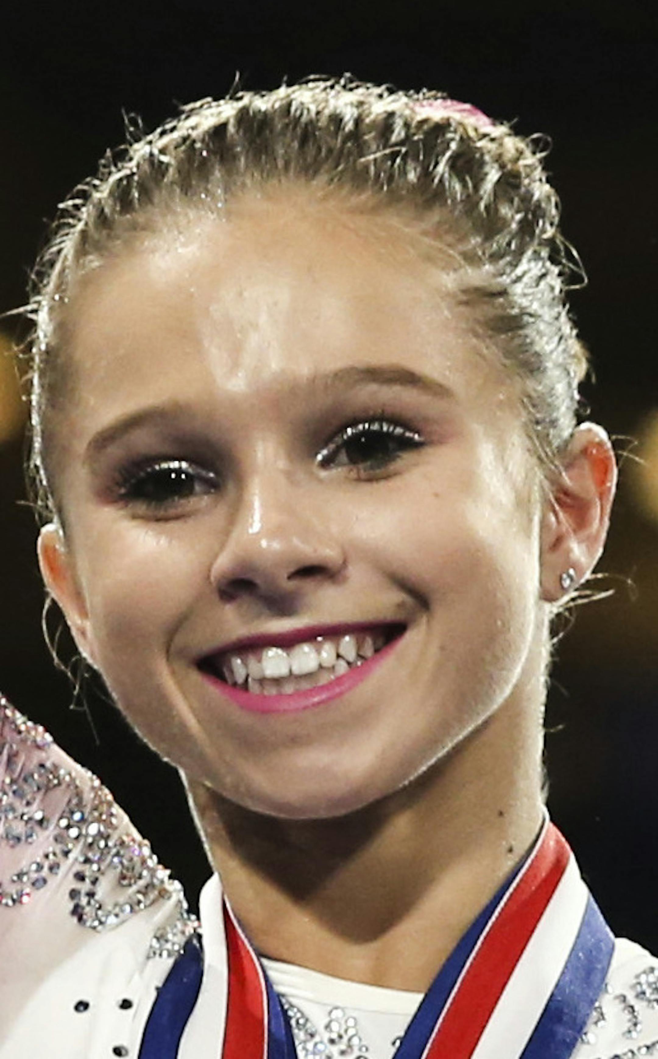 Ragan Smith waves during the medal ceremony after winning the women's all-around at the U.S. gymnastics championships, Sunday, Aug. 20, 2017, in Anaheim, Calif. (AP Photo/Ringo H.W. Chiu)