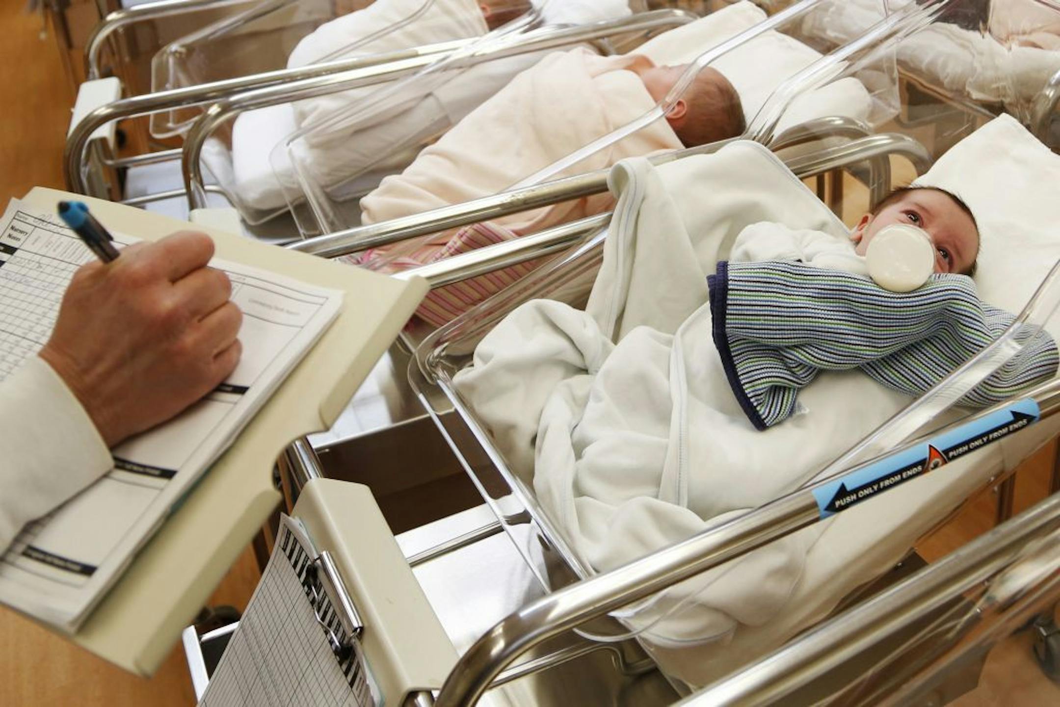 FILE - This Thursday, Feb. 16, 2017 file photo shows newborn babies in the nursery of a postpartum recovery center in upstate New York. According to a Centers for Disease Control and Prevention report released on Thursday, May 17, 2018, 2017 saw the lowest number of U.S. births in 30 years, with birth rates declining not only for women in their teens and 20's but _ surprisingly _ also women in their 30's.