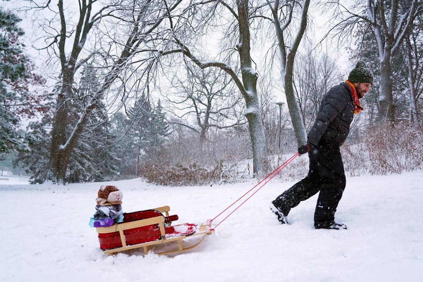 Jared Roddy and his son, Frank, 2, used the sudden snowstorm to go sledding Saturday, Dec. 1, 2018 at Audubon Park in Northeast Minneapolis. The storm dumped between 2 and 4 inches of snow on the Twin Cities with several more inches seen across much of the state.