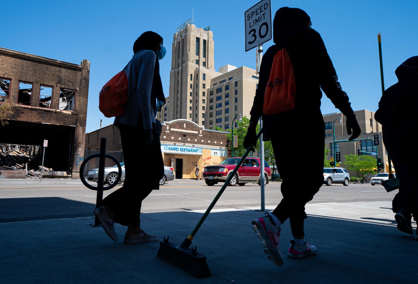 Broom-wielding volunteers walked up and down E. Lake Street, helping with clean-up, June 3.