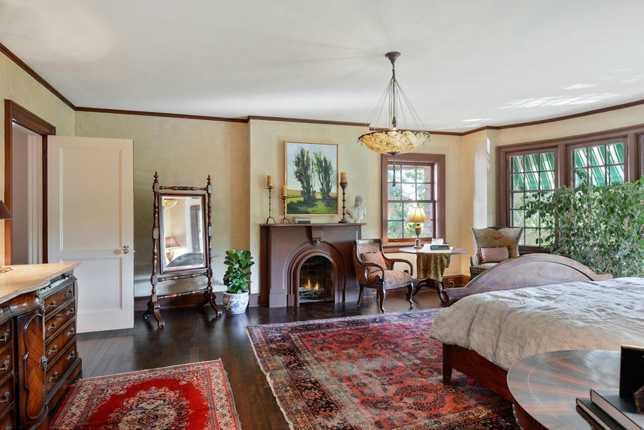 The master bedroom, one of nine in the home, has a fireplace, one of six.