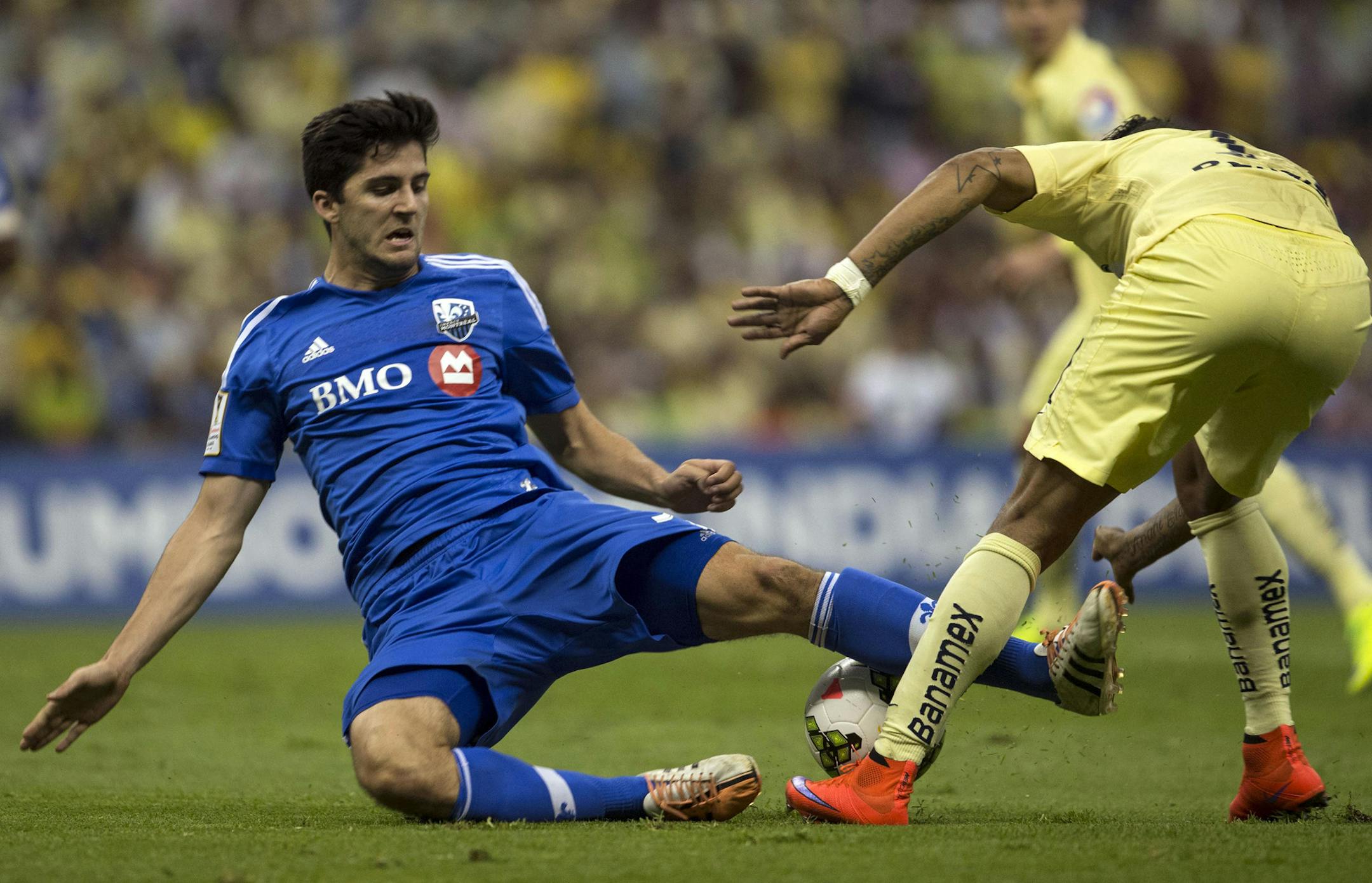 Eric Miller of Canada's Montreal Impact, left, fights for the ball with Michael Arroyo of Mexico's America during a CONCACAF Champions league match in Mexico City, Wednesday, April 22, 2015. The match ended in a 1-1 tie. (AP Photo/Christian Palma) ORG XMIT: MXCP118