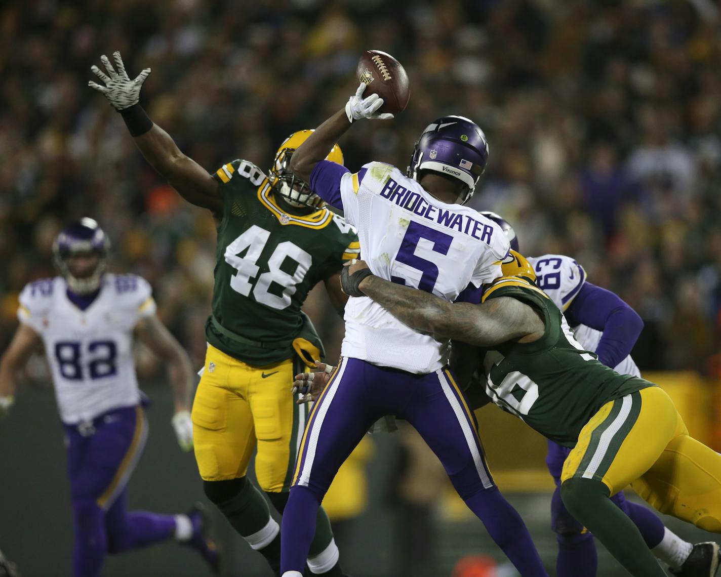 Vikings quarterback Teddy Bridgewater (5) was pressured by Packers linebacker Joe Thomas (48) and Packers outside linebacker Mike Neal (96) in the third quarter Sunday night.