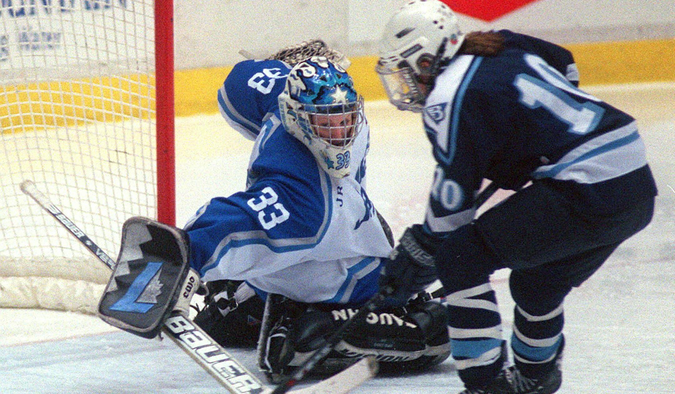 Bloomington Jefferson goalie Larissa Luther (33) keeps her eye on the puck before she made a save on Blaine's Kristina Bunker (10) during the first period Saturday, Feb. 24, 2001, during the girls' state championship game in Falcon Heights, Minn. Bloomington Jefferson defeated Blaine 2-1. (AP Photo/Dawn Villella) ORG XMIT: MIN2014021815372878