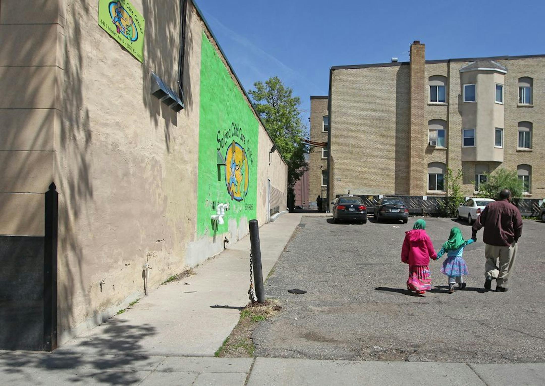 A parent picked up children from the Salama Child Care Center after officials from the DHS and BCA removed boxes and computer equipment, Wednesday, May 13, 2015 in Minneapolis, MN.