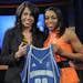 Connecticut's Renee Montgomery, right, holds up a Minnesota Lynx jersey as she poses with WNBA president Donna Orender after Montgomery was chosen as 