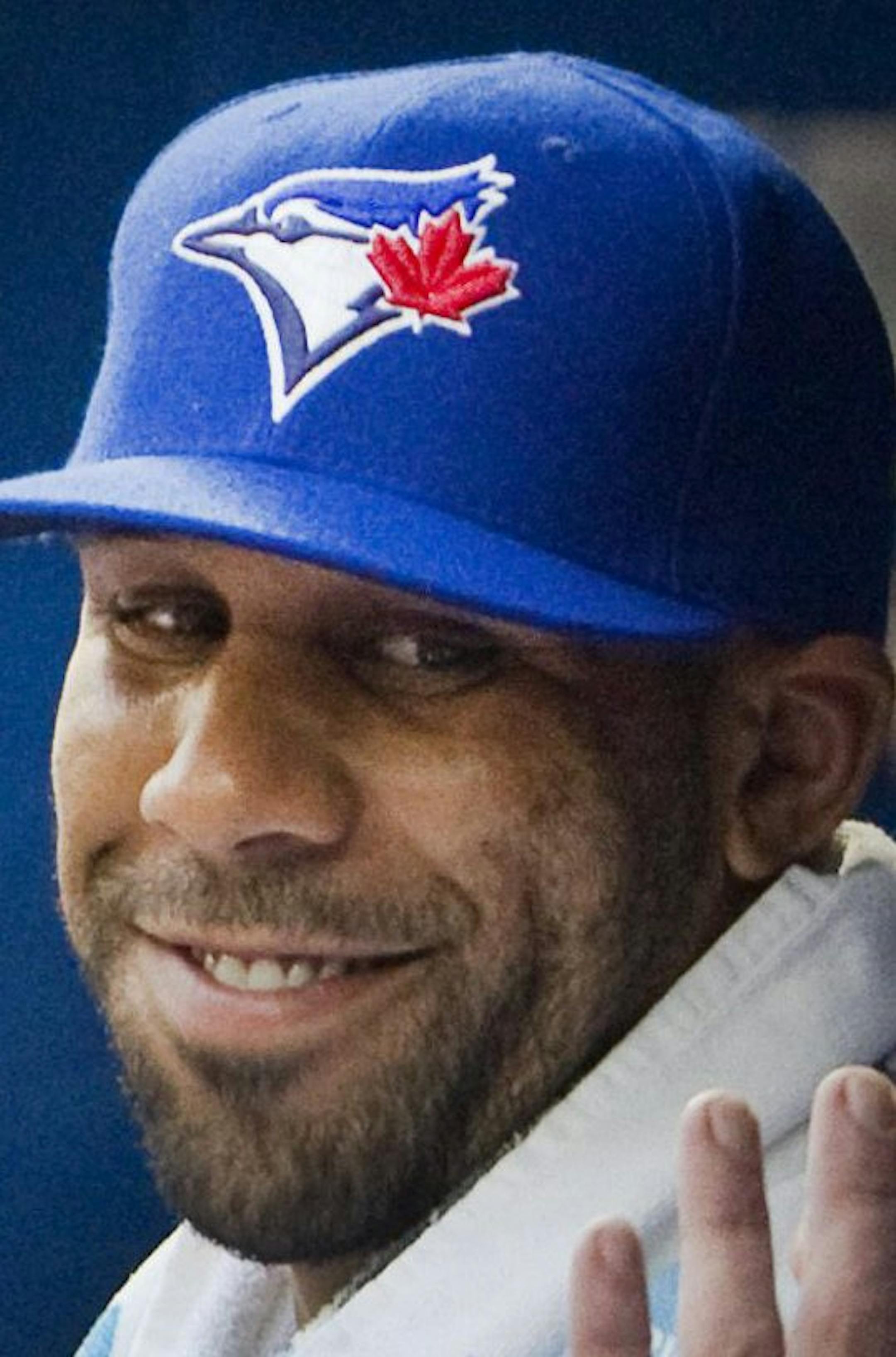 Toronto Blue Jays newly acquired starting pitcher David Price smiles in the dugout with teammate Jose Bautista as his team plays the Kansas City Royals during the second inning of a baseball game, Friday, July 31, 2015 in Toronto. (Fred Thornhill/The Canadian Press via AP) MANDATORY CREDIT