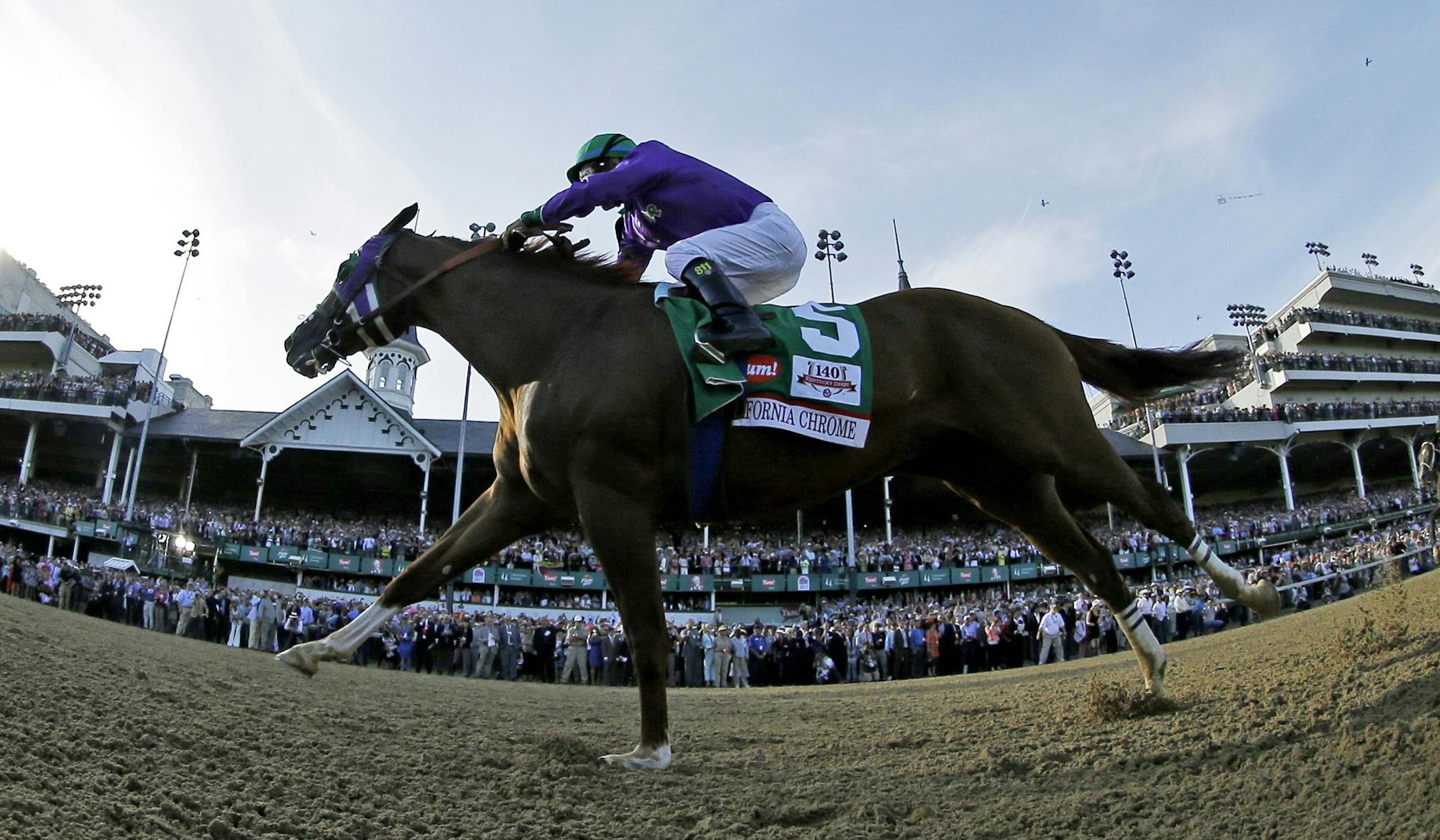 In this image taken with a fisheye lens, Victor Espinoza rides California Chrome to a victory during the 140th running of the Kentucky Derby horse race at Churchill Downs Saturday, May 3, 2014, in Louisville, Ky. (AP Photo/Matt Slocum)