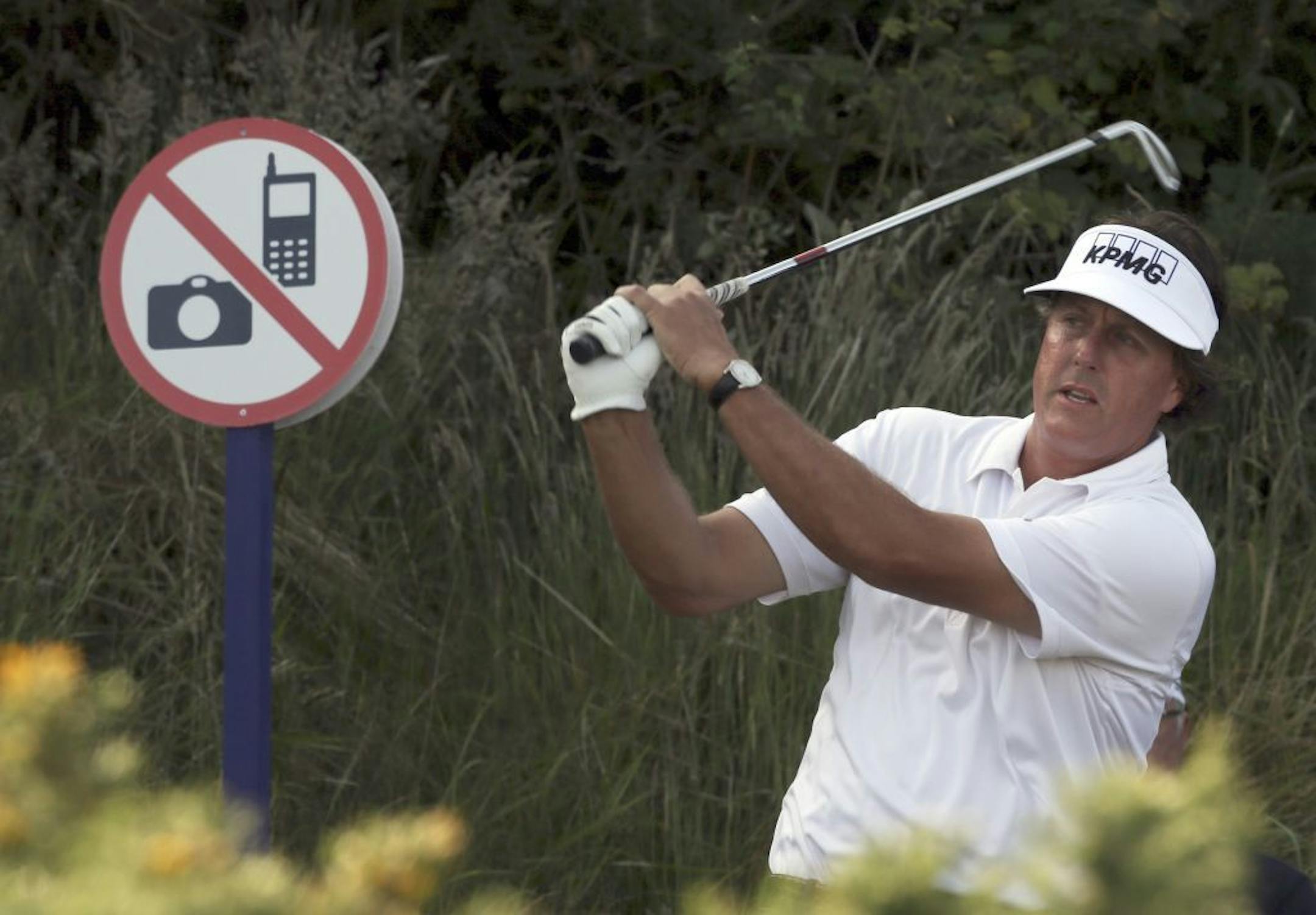 U.S. golfer Phil Mickelson plays a shot on the 10th during day one of the Scottish Open at Castle Stuart Golf Course, Inverness Scotland Thursday July 11, 2013. (AP Photo/David Cheskin/PA) UNITED KINGDOM OUT NO SALES NO ARCHIVE