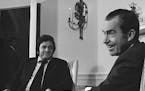 President Richard Nixon smiles for photographers during his meeting with country singer Johnny Cash at the White House, July 26, 1972. Cash visited th
