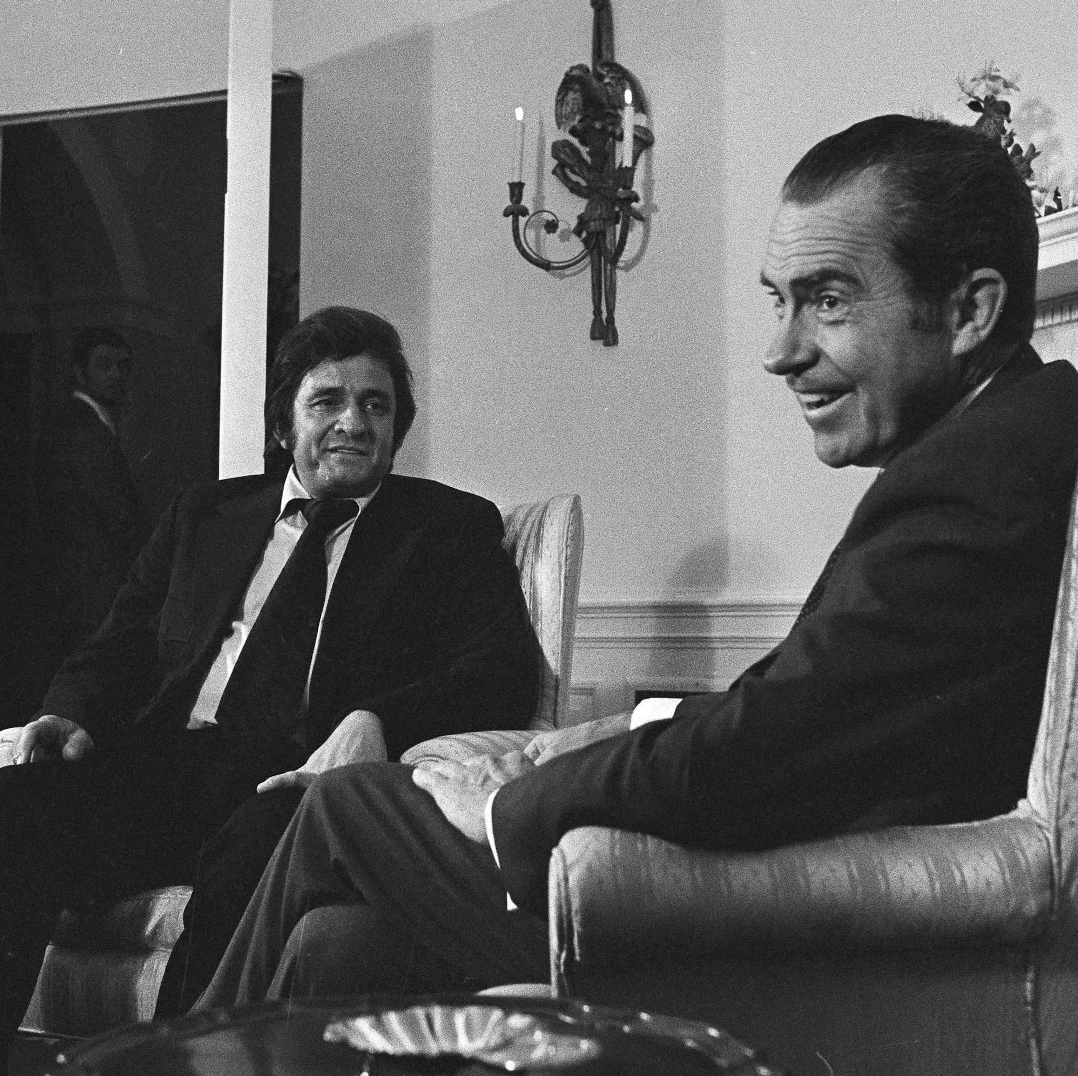 President Richard Nixon smiles for photographers during his meeting with country singer Johnny Cash at the White House, July 26, 1972. Cash visited the president after testifying before the Senate Judiciary subcommittee on parole legislation. (AP Photo/Charles Tasnadi) ORG XMIT: APHS