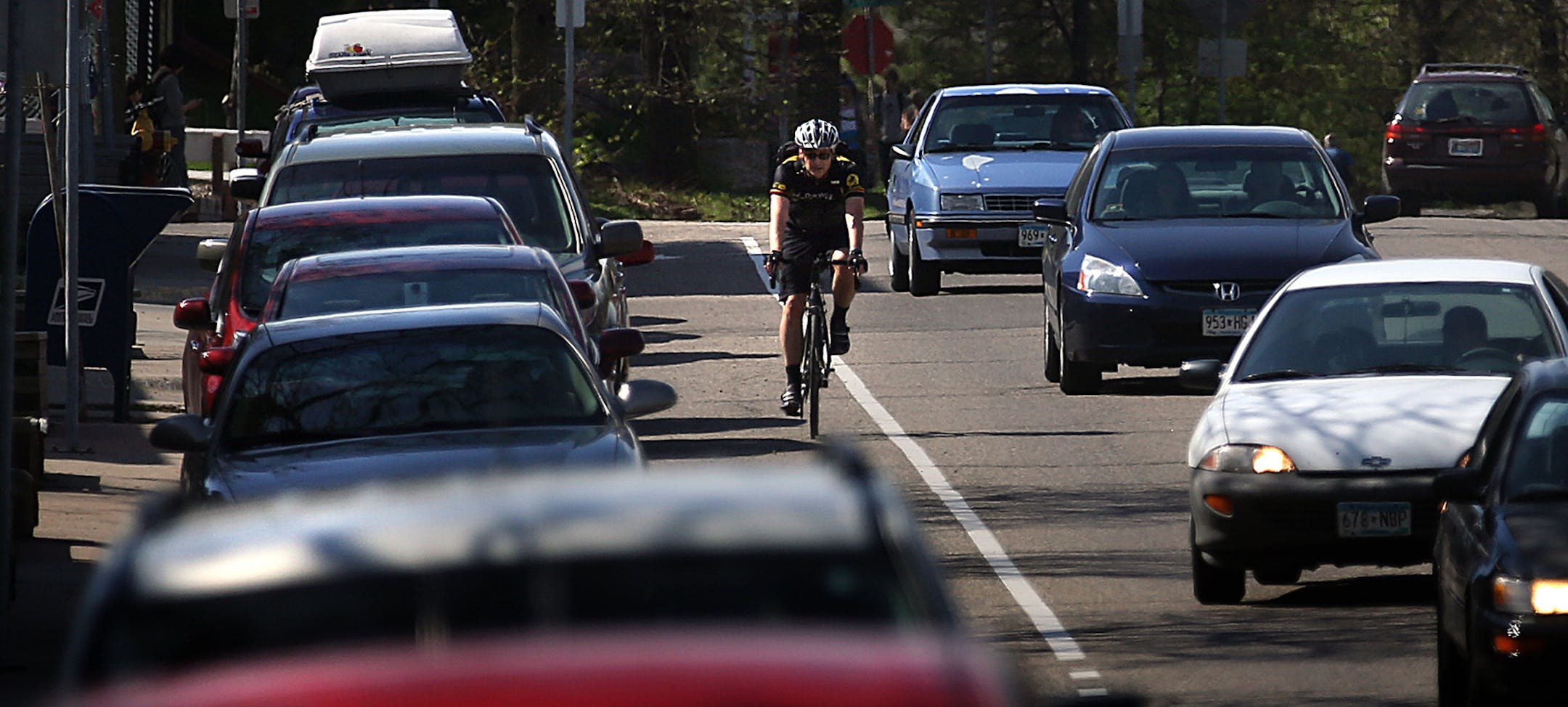 Chuck Hermes rode his bicycle through traffic along Como Ave. during his commute home after work in Minneapolis.