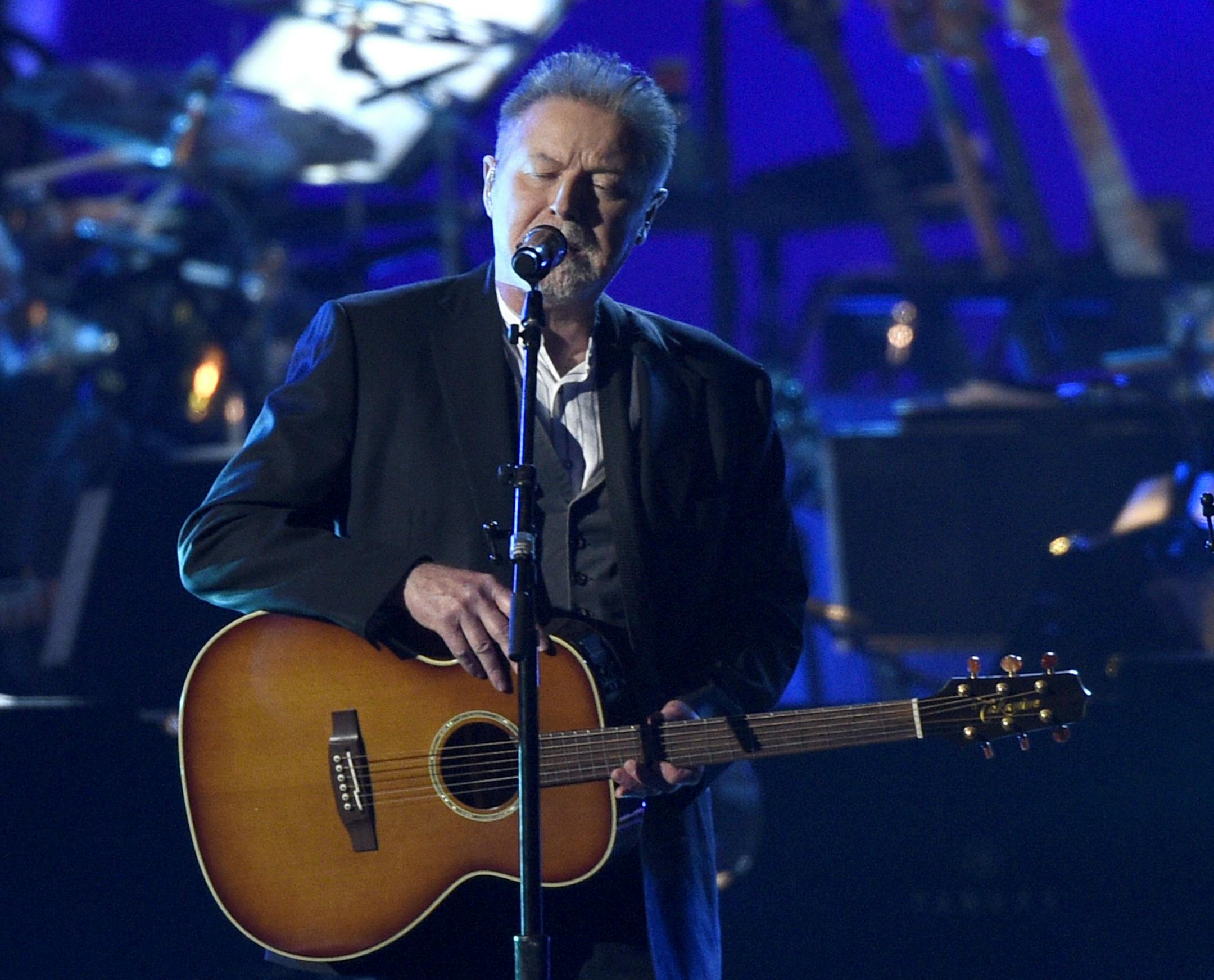 FILE - This Feb. 8, 2019 file photo shows Don Henley, left, and Vince Gill performing "Eagle When She Flies" at MusiCares Person of the Year honoring Dolly Parton in Los Angeles. Eagles, with Deacon Frey and Vince Gill, are planning massive performances of their album "Hotel California" during their 2020 tour. Performances of the band's 1976 album will include a 46-piece orchestra and a 22-voice choir. Organizers announced Tuesday that in total, 77 musicians are expected to be onstage while Eagl