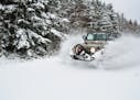 Springhill, Nova Scotia, Canada - November 24, 2011: A Jeep Wrangler 4x4 blasts through fresh powder snow after an early winter snow storm.