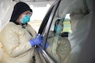 Cheryl Odegaard, a medical assistant at St. Luke's Respiratory Clinic in Duluth, prepared to administer a COVID-19 test to a patient in a drive-throug