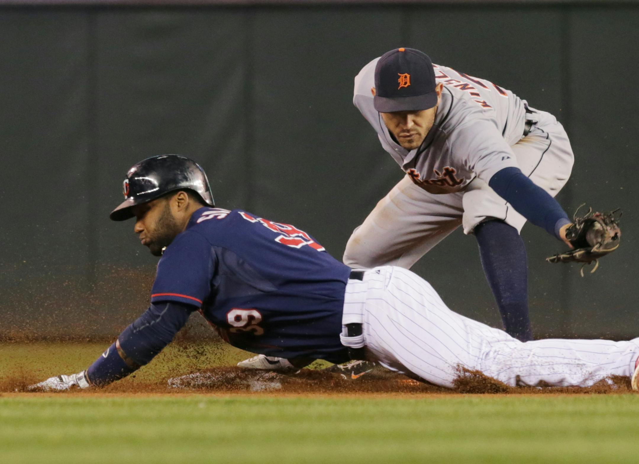 The Twins' Danny Santana, left, doubled off Tigers pitcher Rick Porcello as he beat the tag by Tigers second baseman Ian Kinsler in the fifth inning Tuesday.