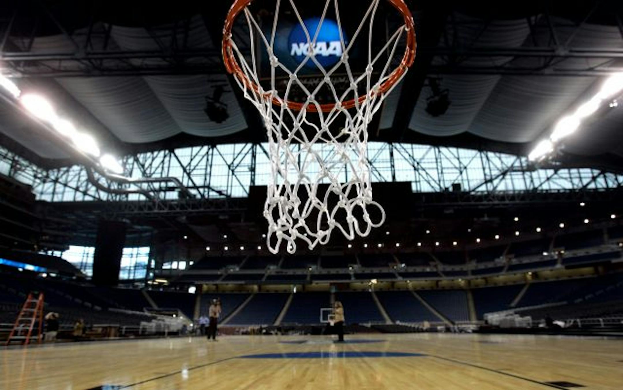 Members of the media looked over the completed basketball court inside Ford Field in Detroit, site of the Midwest Regional.