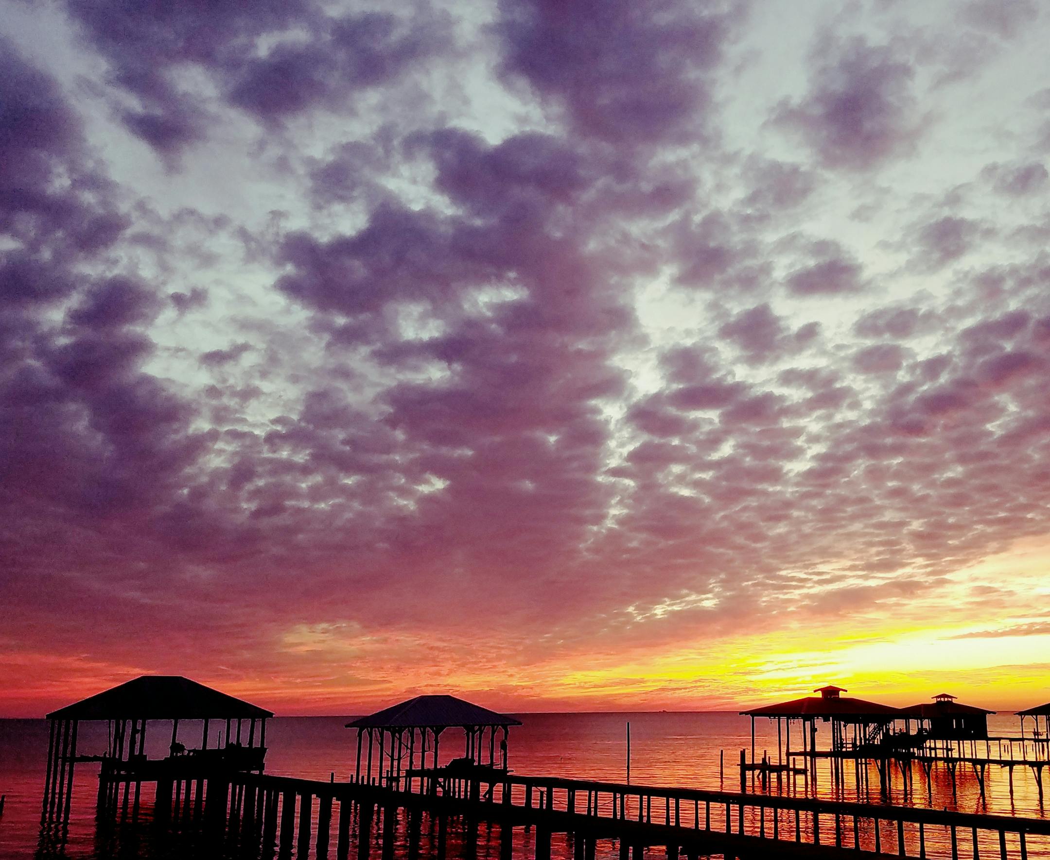 THE TRAVELER: Diane Merz of Elk River
THE SCENE: On the Eastern Shore of Mobile Bay near Fairhope, Alabama, the sun never fails to delight as it sets over the piers.
THE TRIP: My husband and I frequently stay at a little rental on Mobile Bay over Thanksgiving. Most of the homes there have these long piers, some with fancy cabanas at the end with giant-screen TVís and cooking facilities. Some of the piers were destroyed in Hurricane Nate; some have been rebuilt. A favorite snoozing spot for