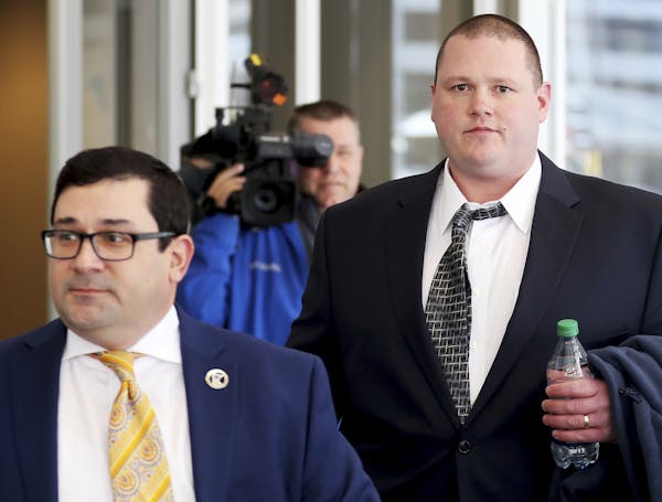 Former Minneapolis police officer Christopher Reiter, 36, right, arrives at court with his attorney Robert Fowler Thursday, March 16, 2017, at the Hen