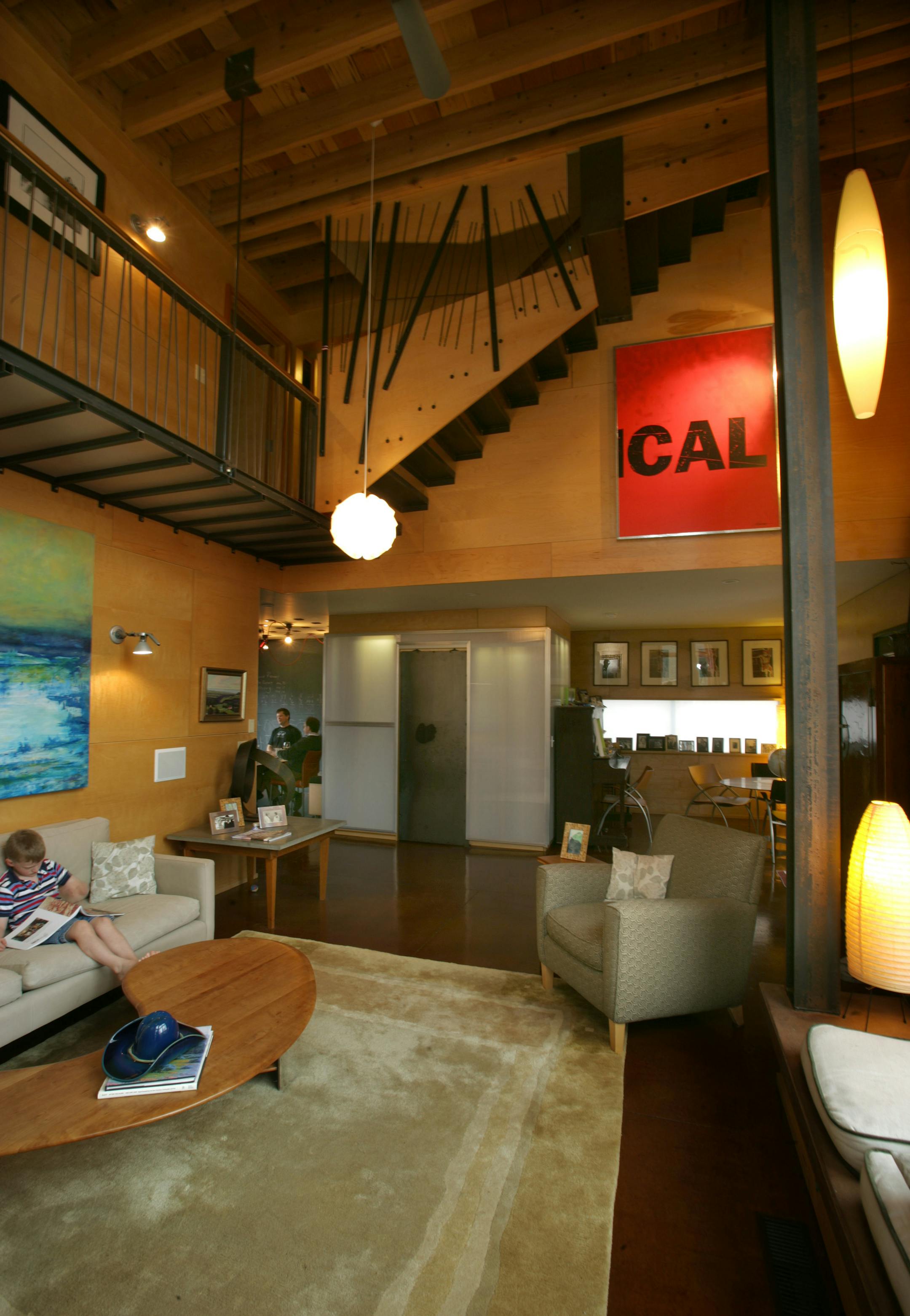 Architect Wynne Yelland of Locus Architecture created his own Minneapolis home, dubbed "Nowhaus 01," as a model of sustainable urban design. The home incorporates low-maintenance materials and recycled items, including salvaged billboards. "Your house is one of the few things that can be customized," Yelland said. "You don't have to pick what your neighbor picked." His son Morgan reads a book on the living-room couch.