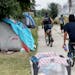 Kariece Wilson, 26, is among the more than 50 people who live at the large encampment along Hiawatha and Cedar Avenues and seen in her tent Tuesday, A