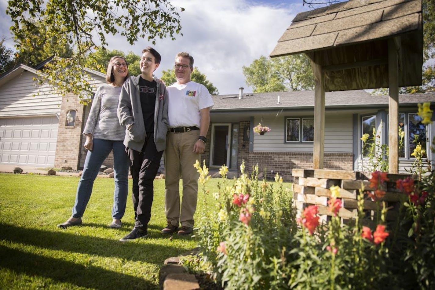 Gideon, center, with his host parents Carolyn and Jeff Anderson outside their home in Andover.