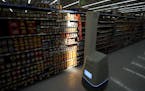 In this Friday, Nov. 9, 2018, photo a Bossa Nova robot scans shelves to help provide associates with real-time inventory data at a Walmart Supercenter
