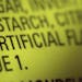 This Thursday, Nov. 8, 2018 photo shows part of an ingredient label, which lists "artificial flavoring," on a packet of candy in New York. In November