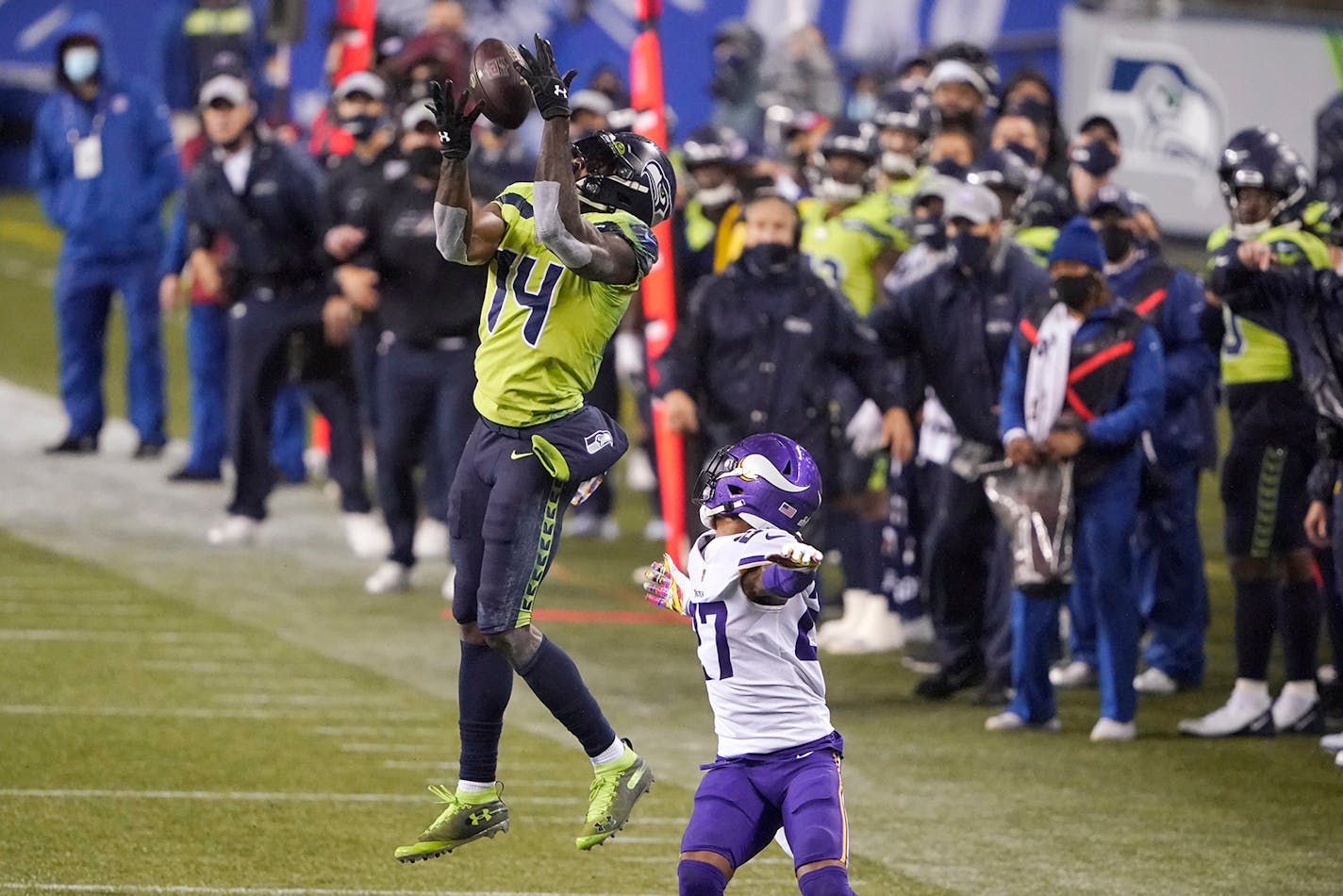 Seattle Seahawks' DK Metcalf (14) pulls in a long pass reception on the Seahawks' last series of an NFL football game as Minnesota Vikings' Cameron Dantzler defends late in the second half, Sunday, Oct. 11, 2020, in Seattle.