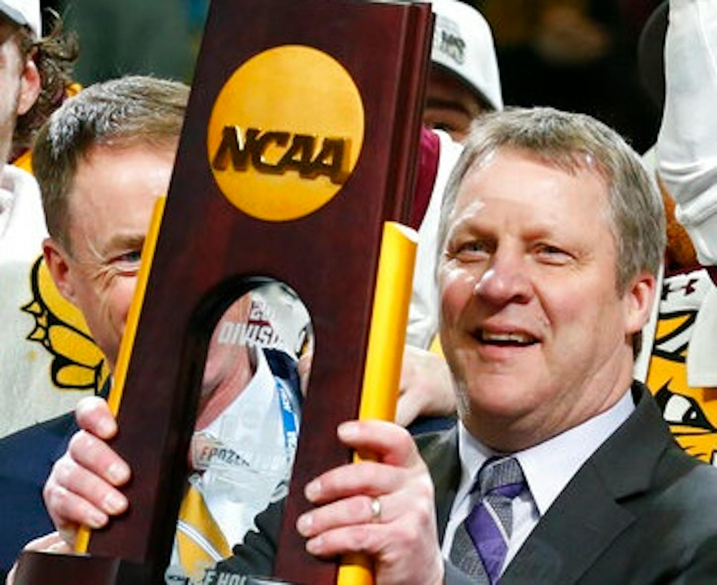 Minnesota-Duluth coach Scott Sandelin celebrates the team's 3-0 victory over Massachusetts in the NCAA Frozen Four men's college hockey championship game Saturday, April 13, 2019, in Buffalo, N.Y. (AP Photo/Jeffrey T. Barnes) ORG XMIT: NYJB117