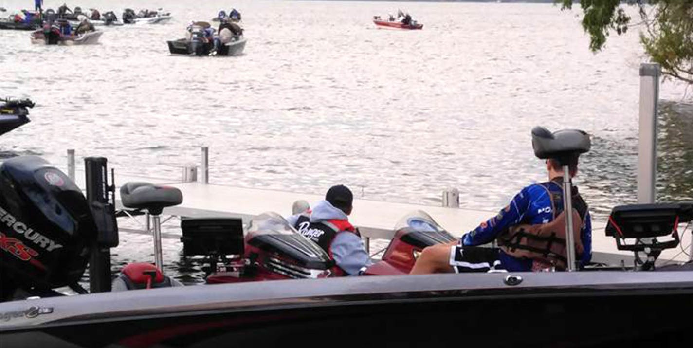 Lexi Ruggles, above, a member of the Brainerd High School fishing team, held a bass she caught during a 2017 tournament on Gull Lake. Below a boat captain for the Brainerd team prepared to launch at the same tournament. Jason Bahr, Brainerd's coach, hopes the Minnesota State High School League becomes a "presenting partner" at a season-ending bass fishing event.