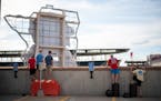 Fans were resourceful finding things to stand on to see over the wall on the top floor of a parking ramp across from Target Field recently to watch th