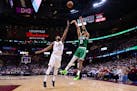 Boston Celtics forward Jayson Tatum (0) shoots over Cleveland Cavaliers center Tristan Thompson (13) during the second half of Game 4.