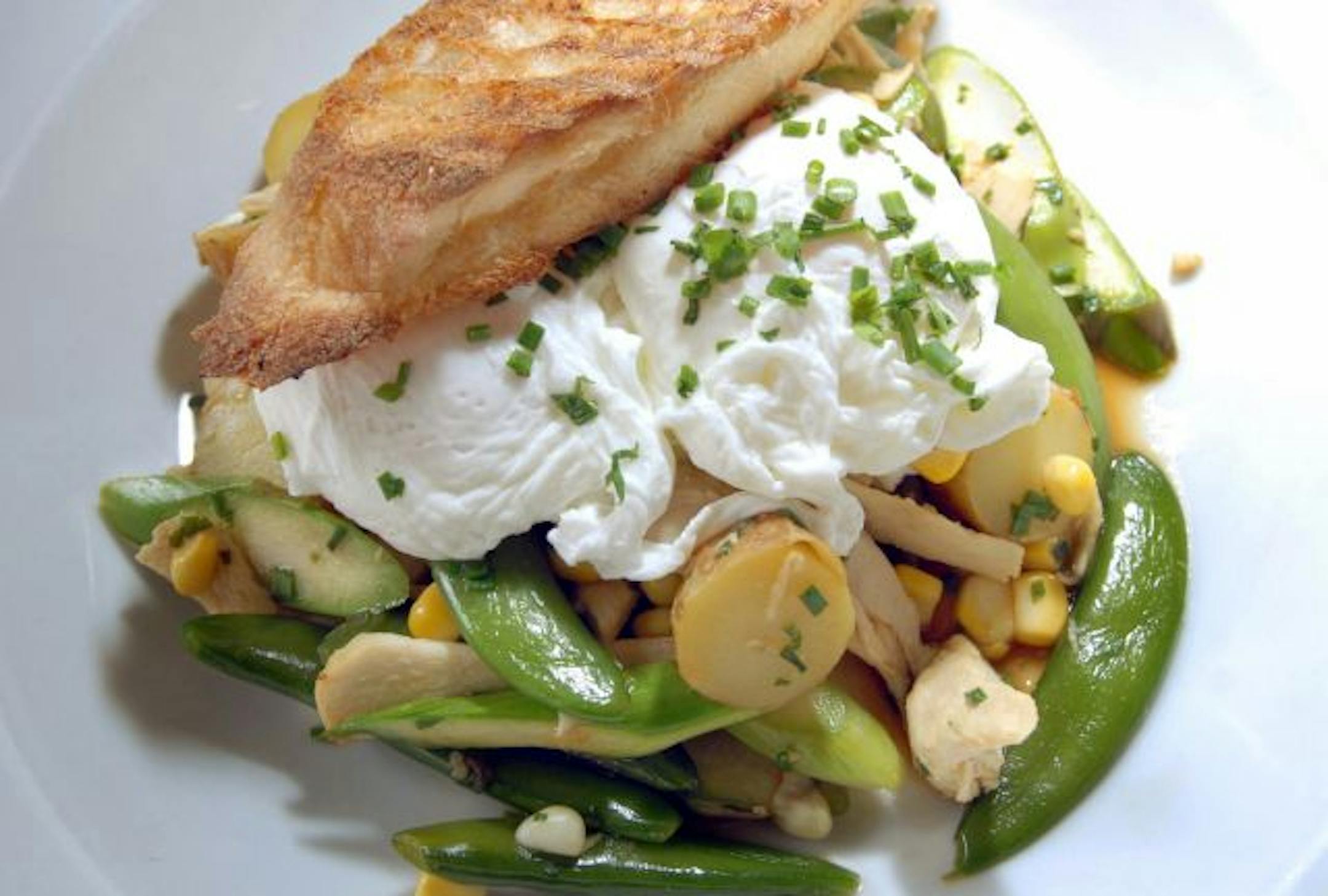 Smoked-chicken and spring-vegetable hash with eggs and toast at Barbette.