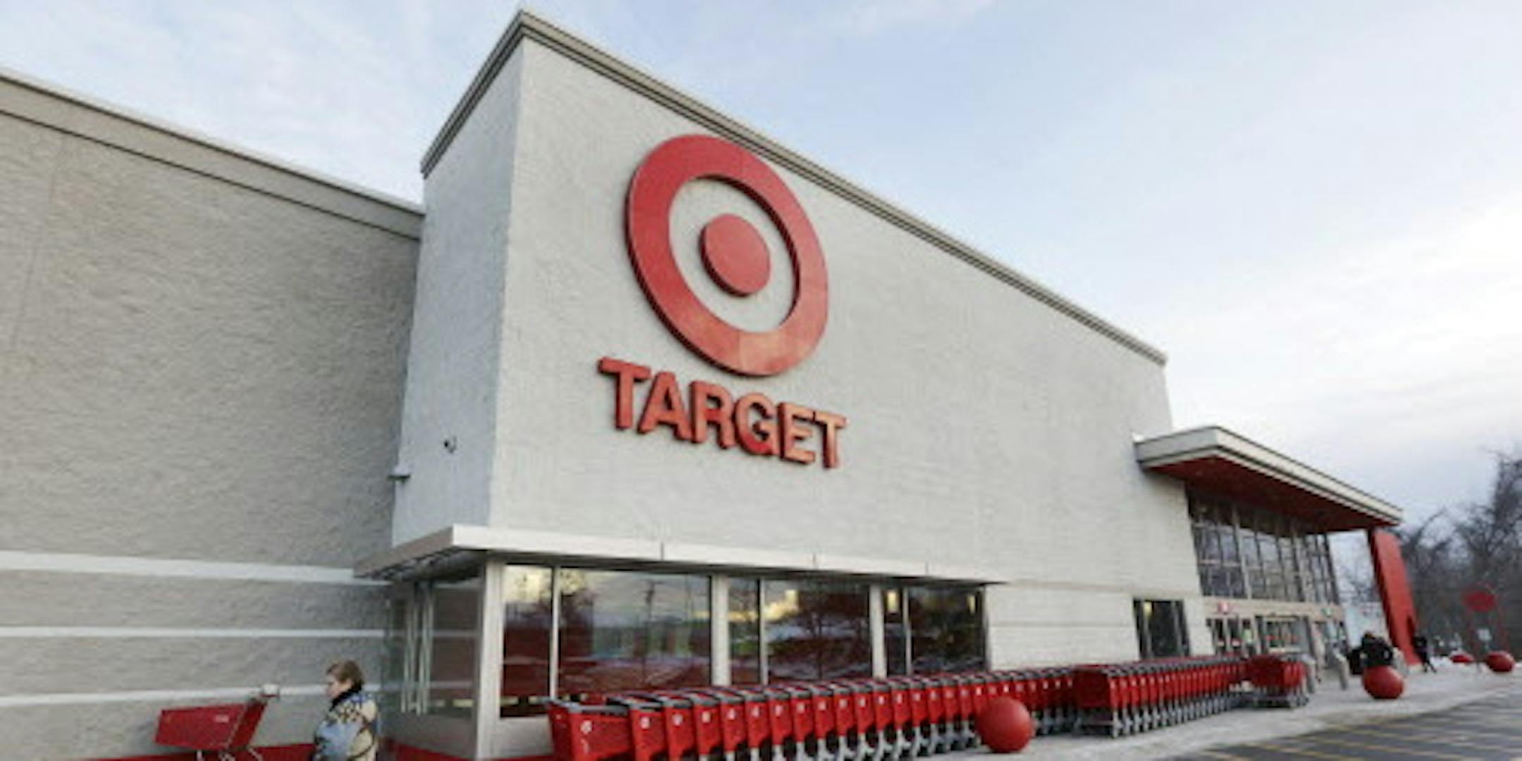 FILE - In this Dec. 19, 2013, file photo, a passer-by walks near an entrance to a Target retail store in Watertown, Mass. Target says that personal information &#xf3; including phone numbers and email and mailing addresses &#xf3; was stolen from as many as 70 million customers in its pre-Christmas data breach. That was substantially more customers than Target had previously said were affected. (AP Photo/Steven Senne, File)