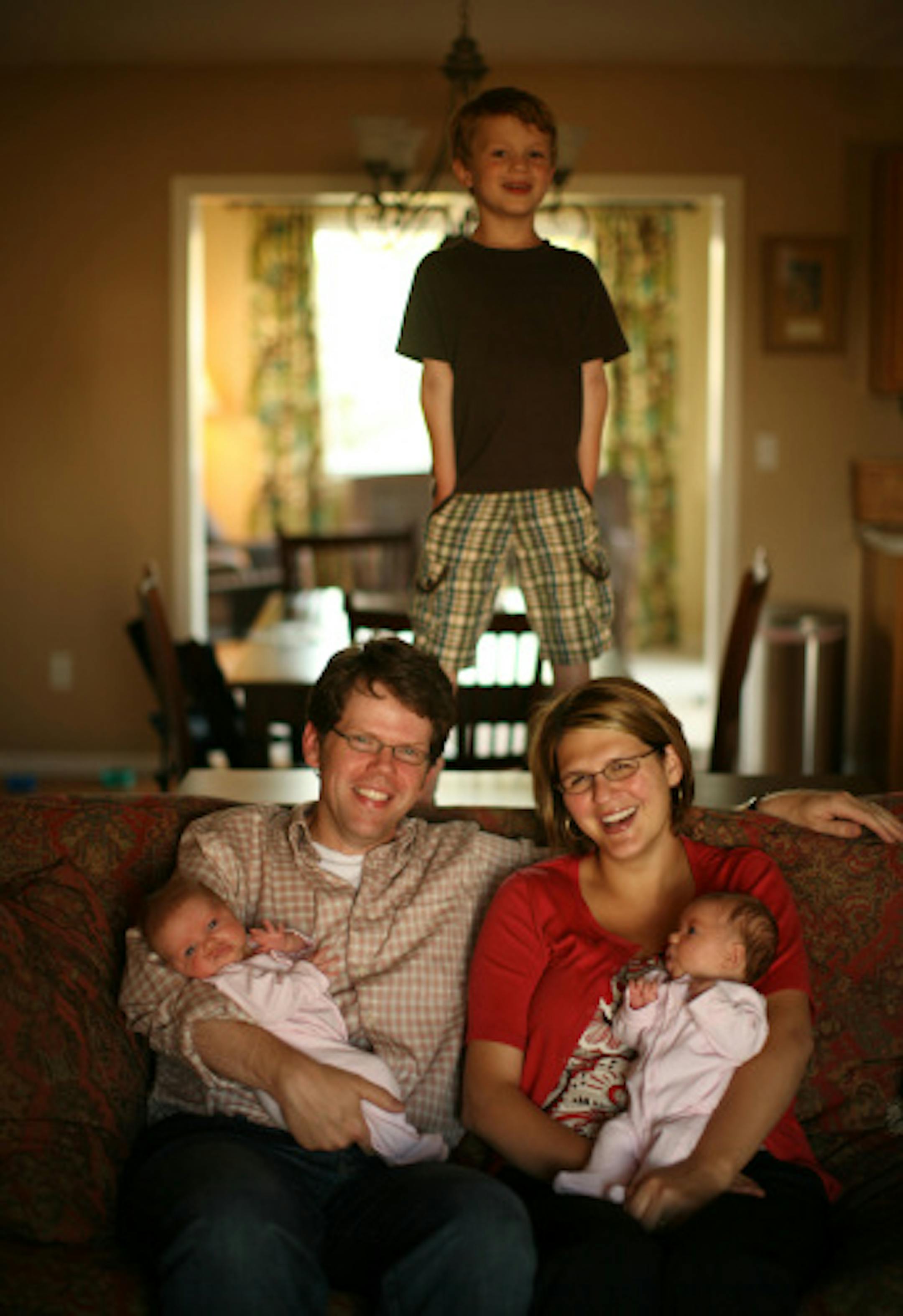 Five-year-old Jonathan Jr. was still king of the mountain Tuesday as he looked over Mom and Dad, Jonathan and Ceresa Caudill, and his 2-month-old twin sisters, Elizabeth, left, and McKinney, at the family's home in Rochester on Tuesday night.