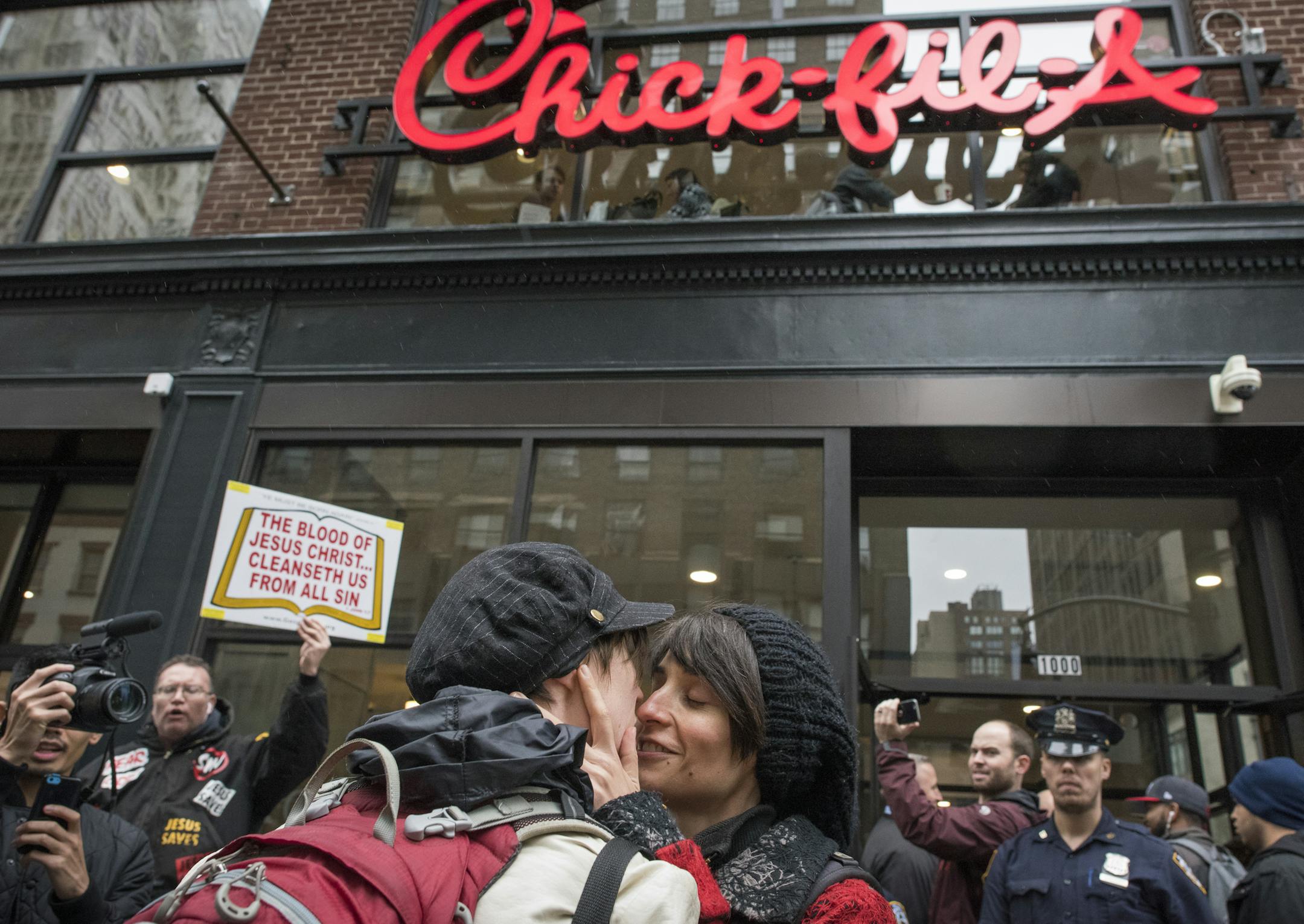A &#xec;kiss-in&#xee; demonstration outside the Chick-fil-A restaurant on Sixth Avenue in Midtown on its opening day in New York, Oct. 3, 2015.