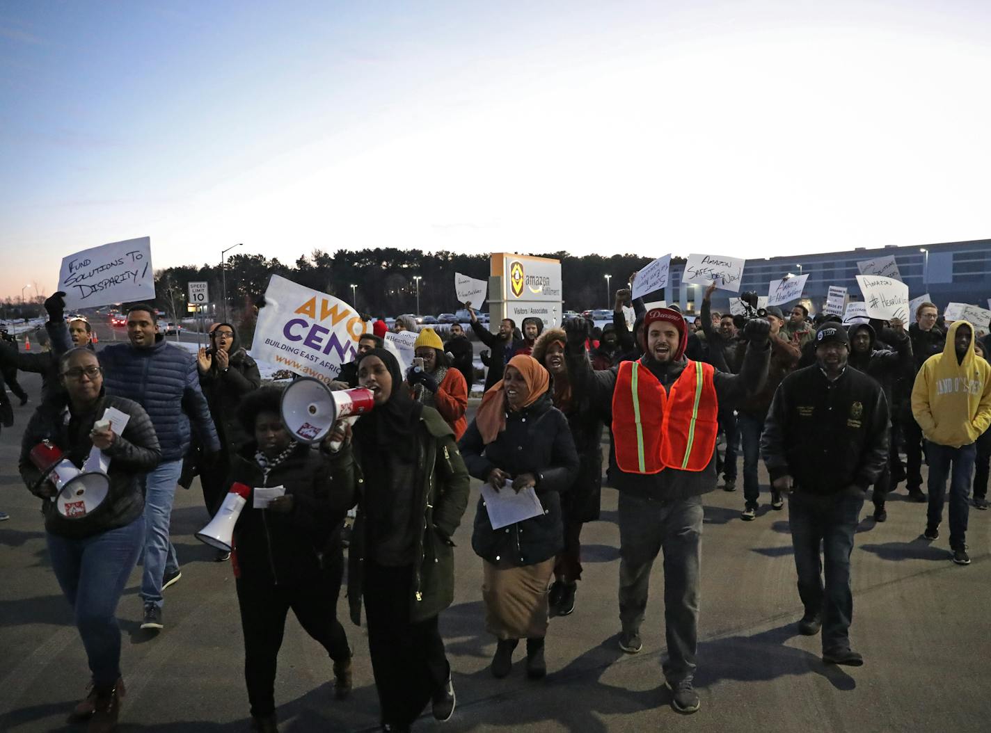 Somali leaders from the Council on American-Islamic Relations of Minnesota, the Muslim Coalition of ISAIAH, and other community members gathered outside the Amazon fulfillment center in Shakopee to protest racial disparities and working conditions on Friday, Dec. 14, 2018. ] Shari L. Gross &#xef; shari.gross@startribune.com Somali leaders with the Muslim Coalition of ISAIAH (MCI), Council on American-Islamic Relations of Minnesota (CAIR MN) and community allies gathered outside the Amazon fulfil