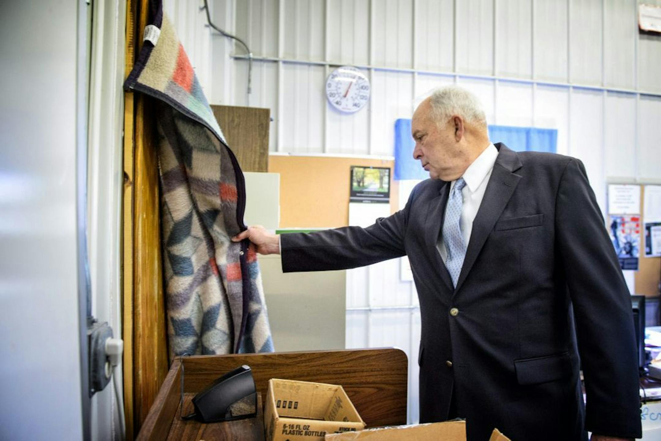 Rep John Kline lifted up a blanked draped over an uninsulated door used in an effort to keep out the cold in a building that was once used for a vocational auto body shop and never intended to be used as classroom space. The building has a leaky roof, poor insulation and an overburdened electrical system.