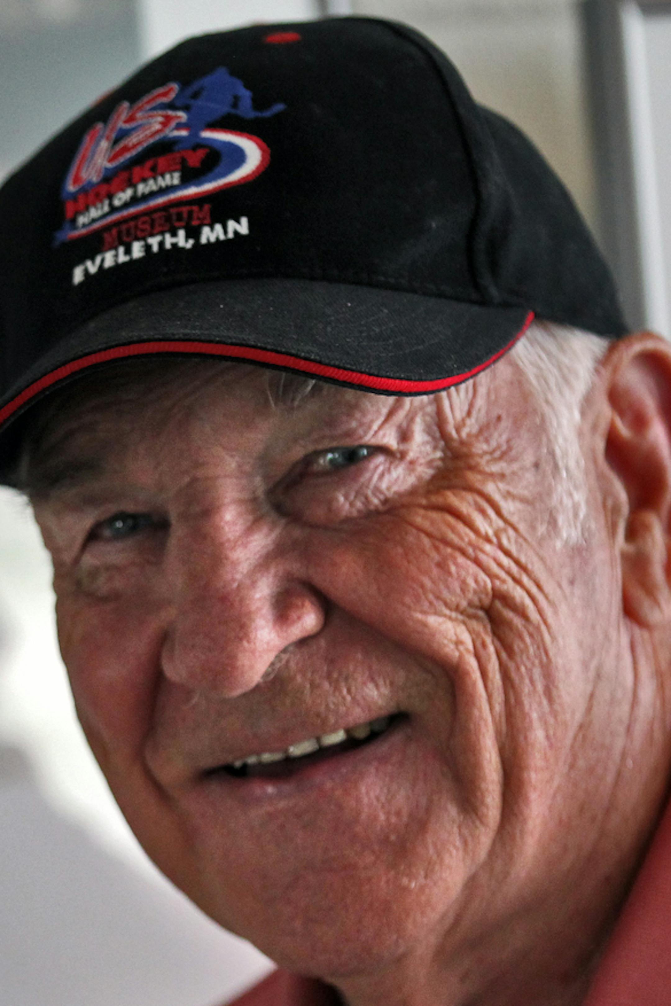 Profile of John Mayasich, now 80, one of the most prolific amateur hockey players in Minnesota during his playing days in the 1940's and 50's. He has retired to Eveleth, his hometown of hockey fame. Mayasich stopped next to a photo of his UM hockey coach, the legendary John Marriucci, on display at Eveleth's Hockey Hall of Fame. (MARLIN LEVISON/STARTRIBUNE(mlevison@startribune.com
