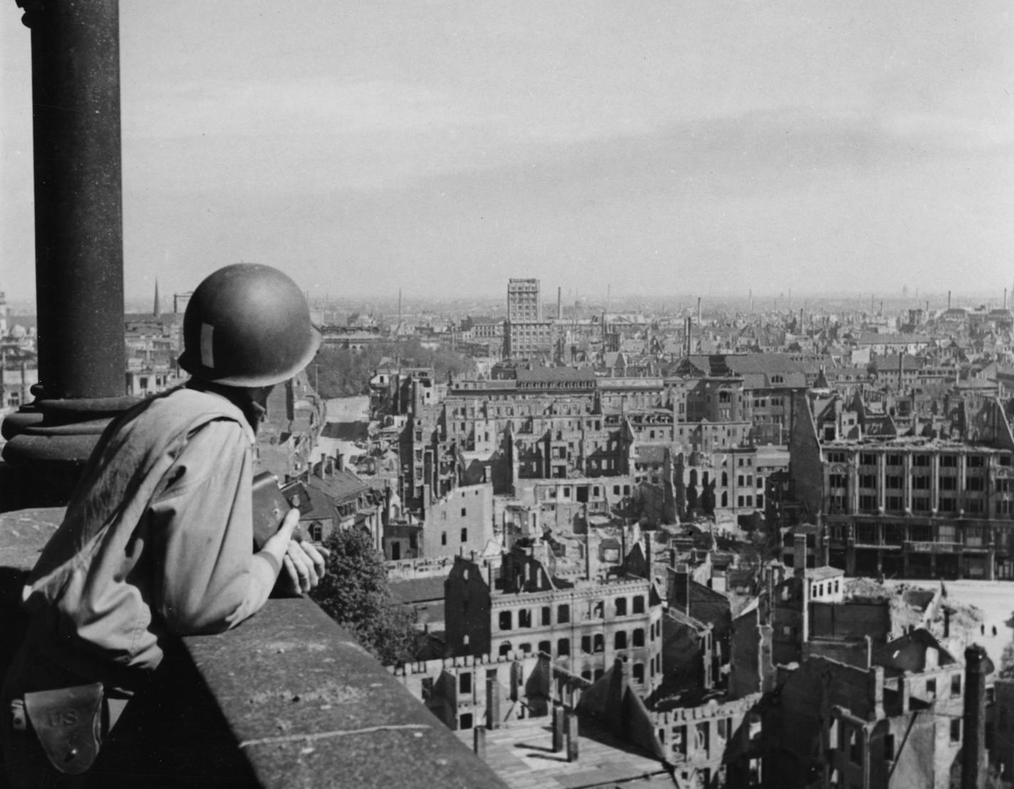 An American lieutenant looks out over the German city of Leipzig from an observation platform on the spire of the cathedral. All buildings within range of the camera have either been totally destroyed or damaged by bombs or artillery fire. Photo by Allan Jackson, INP pool photographer. Photo taken or moved 4/28/1945. ORG XMIT: MERfe5df4b804c2888c3004a2d79cfcc