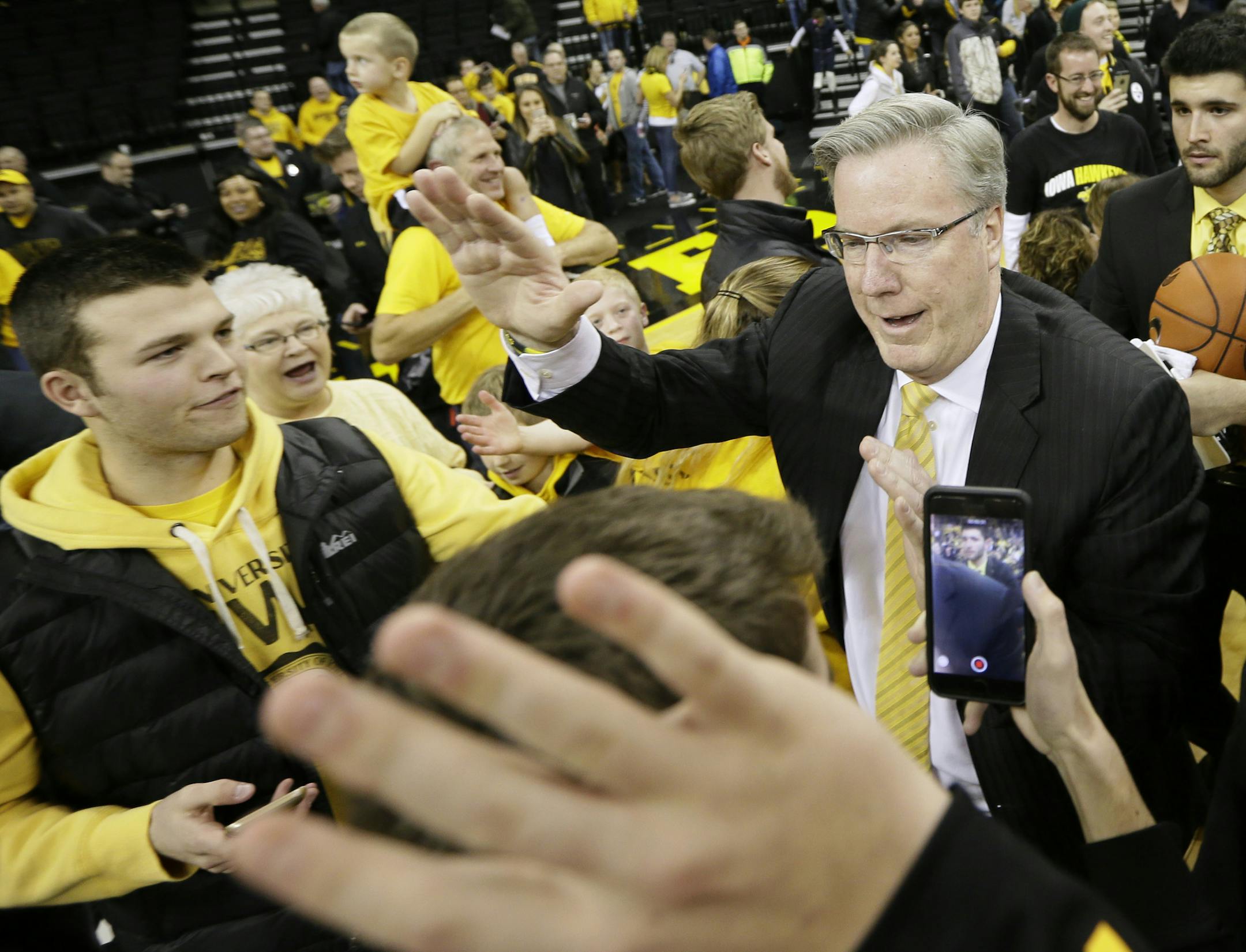 Iowa head coach Fran McCaffery celebrates with fans after an NCAA college basketball game against Michigan State, Tuesday, Dec. 29, 2015, in Iowa City, Iowa. Iowa won 83-70. (AP Photo/Charlie Neibergall)