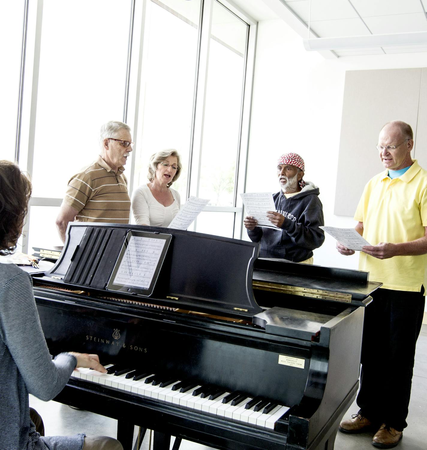 Standing left to right, Charles Reinhart, Cindy Dittmer, Krishna Seshan, and Gary Anderson work on a song in Andrea Leap's Singing Basics class at MacPhail Center for Music in Minneapolis July 15, 2014. (Courtney Perry/Special to the Star Tribune)