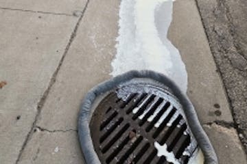 This photo provided by the Minnesota Pollution Control Agency shows raw cream from Plainview Milk Products Cooperative in Wabasha County draining into