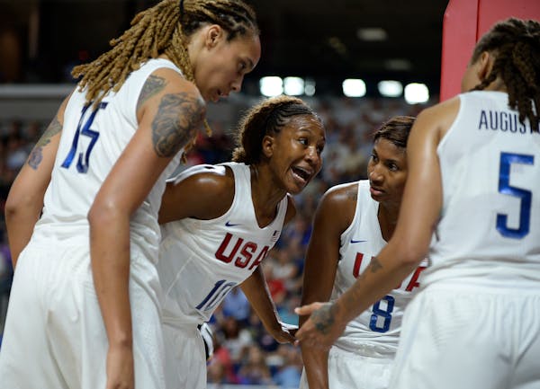 The United States' Tamika Catchings, second from left, huddled with teammates (from left) Brittney Griner, Angel McCoughtry and Seimone Augustus durin