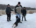 Mark Freer, his grandson Noah and Charlotte Svobodny play with Josie, Freer's dog, at the future site of the Inver Grove Heights dog park.